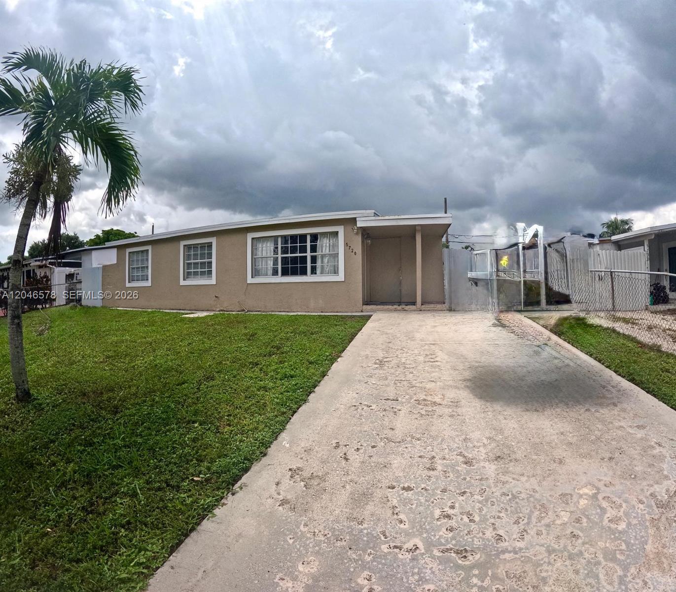 A single-story house with a concrete driveway, a front lawn, and a palm tree — 5720 SW 38th Ct # 5720, Davie FL 33314, DAVIE, FL