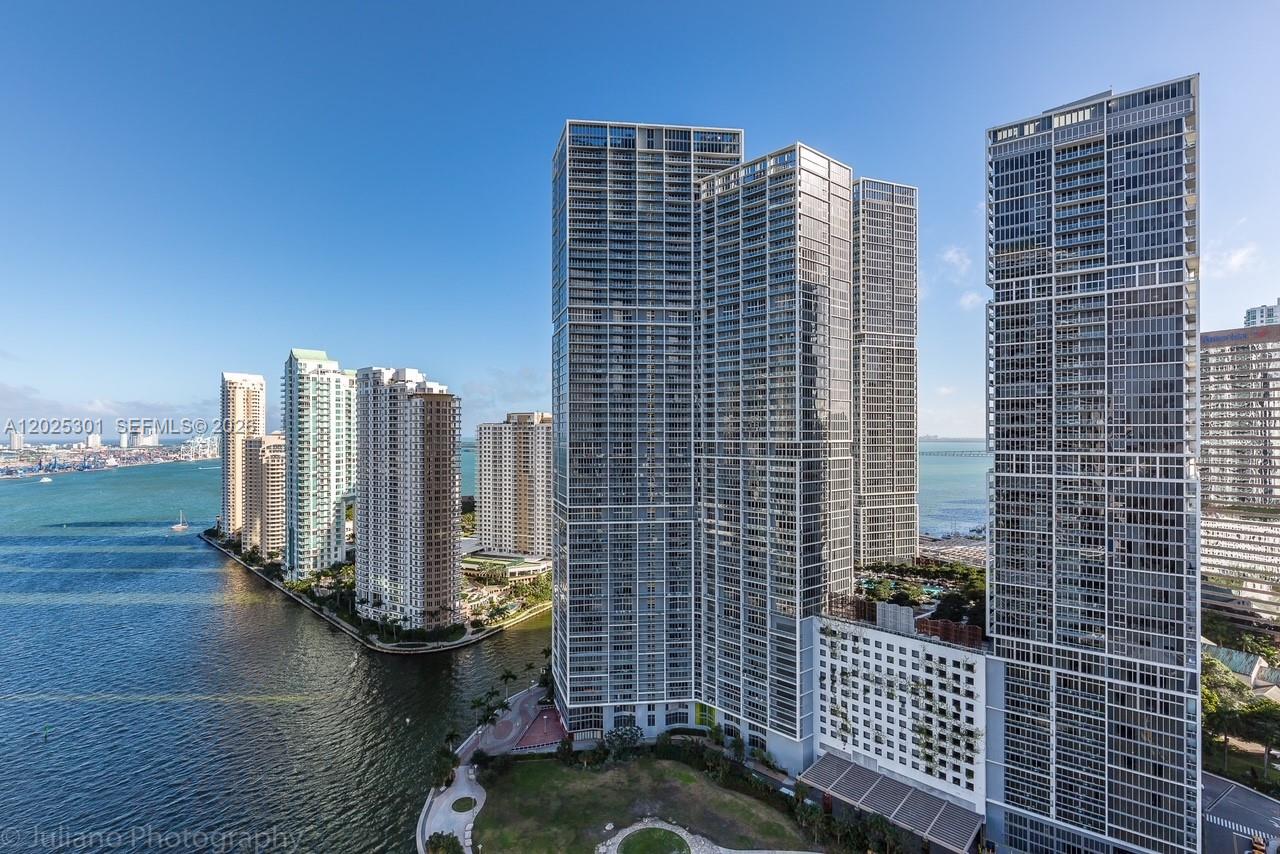 An aerial view of several tall residential skyscrapers situated along a waterfront in Miami — 200 Biscayne Boulevard Way # 3102, Miami FL 33131, MIAMI, FL