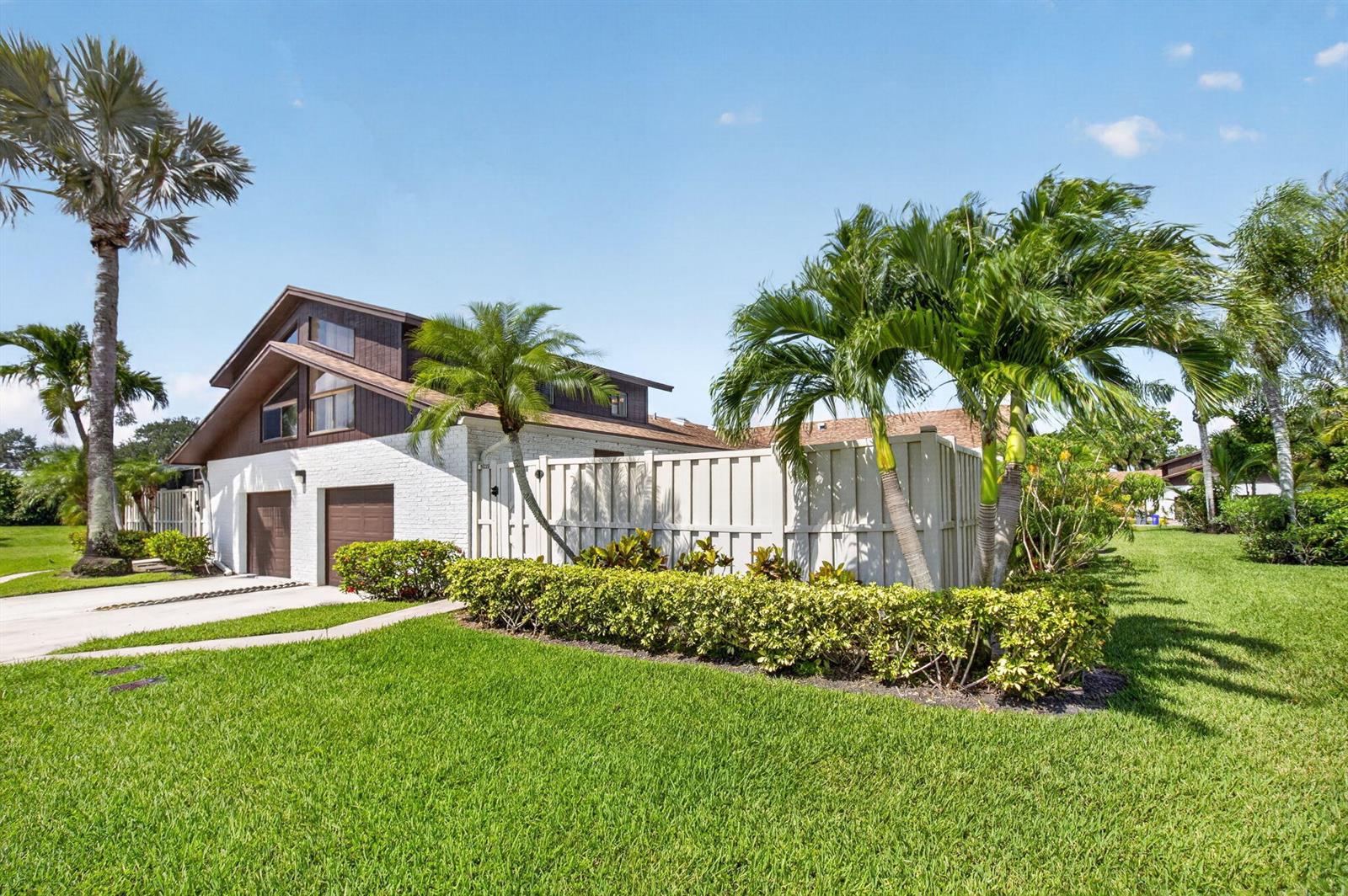 A two-story house with white brick, brown siding, and a fenced yard with palm trees — 9622 Boca Gardens Parkway # B, Boca Raton FL 33496, BOCA RATON, FL