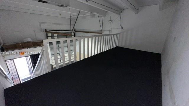 An elevated carpeted loft area overlooks a lower level with a white wooden railing — 12153 SW 131st Ave, Miami FL 33186, MIAMI, FL