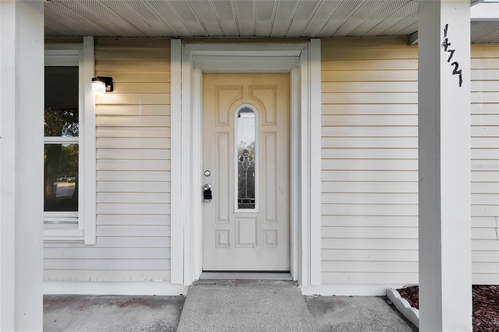A front entrance features a light-colored door with a glass insert and white siding — 14721 SW 35TH TERRACE ROAD, OCALA, FL