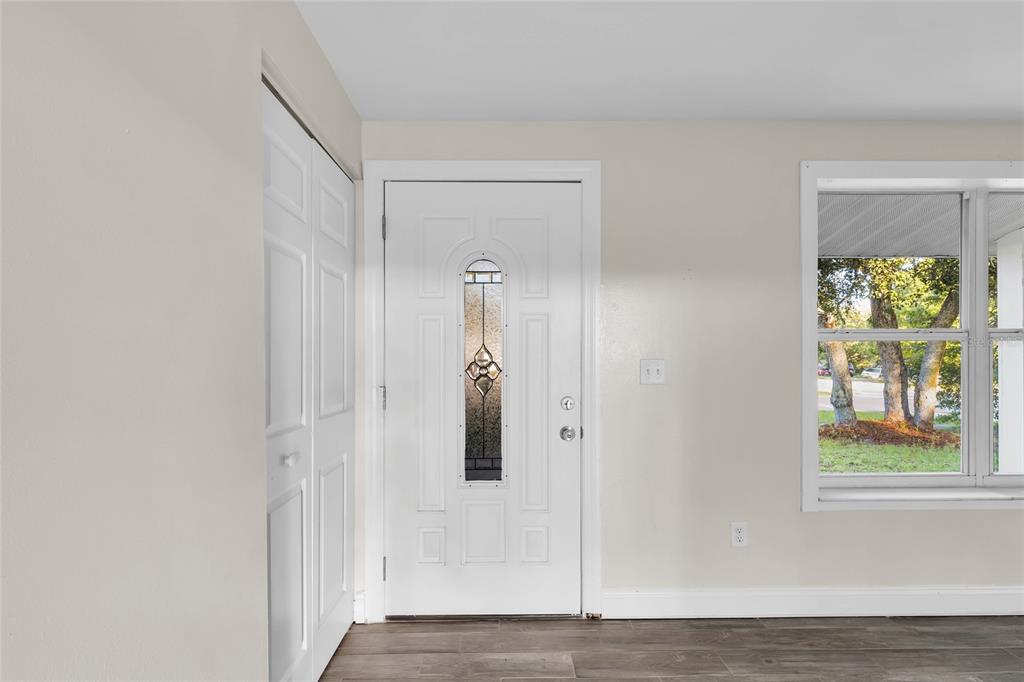 An interior view of an entryway featuring a white front door, a closet, and window — 14721 SW 35TH TERRACE ROAD, OCALA, FL