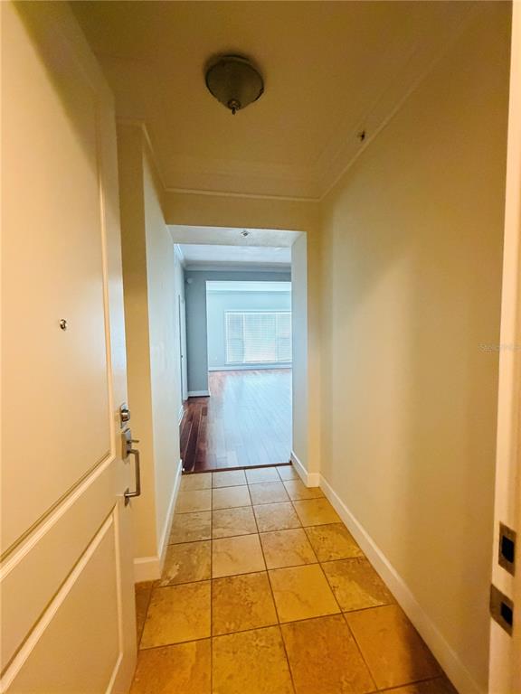 A tiled entryway leads into a living area with hardwood floors and large windows — 2305 EDGEWATER DRIVE UNIT 1708, ORLANDO, FL