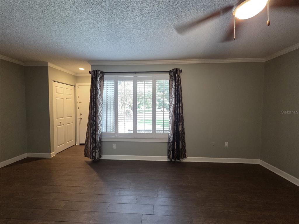 A kitchen with dark wood cabinets, stainless steel appliances, and granite countertops — 2478 FOREST WAY, GAINESVILLE, FL