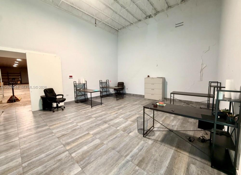 An office space features tile flooring, high ceilings, and several desks with chairs — 6236 Miramar Pkwy, Miramar FL 33023, MIRAMAR, FL