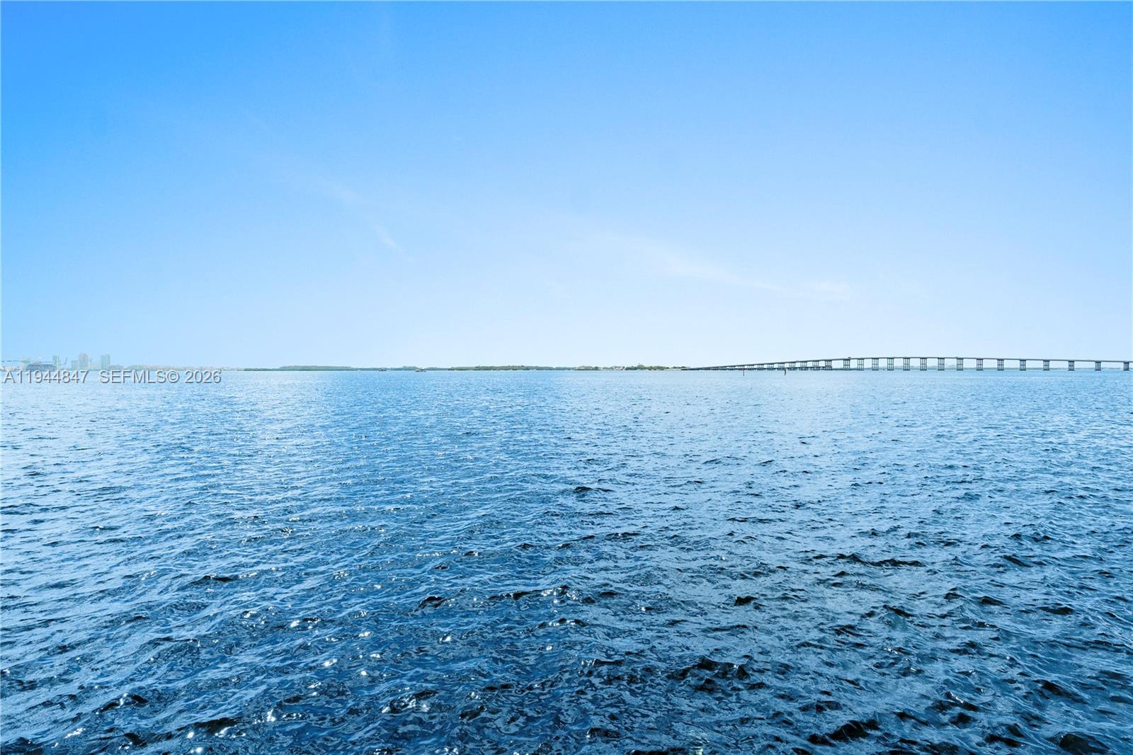 A view of a calm body of water with a long bridge in the distance — 200 SE 15th Rd # 5D, Miami FL 33129, MIAMI, FL