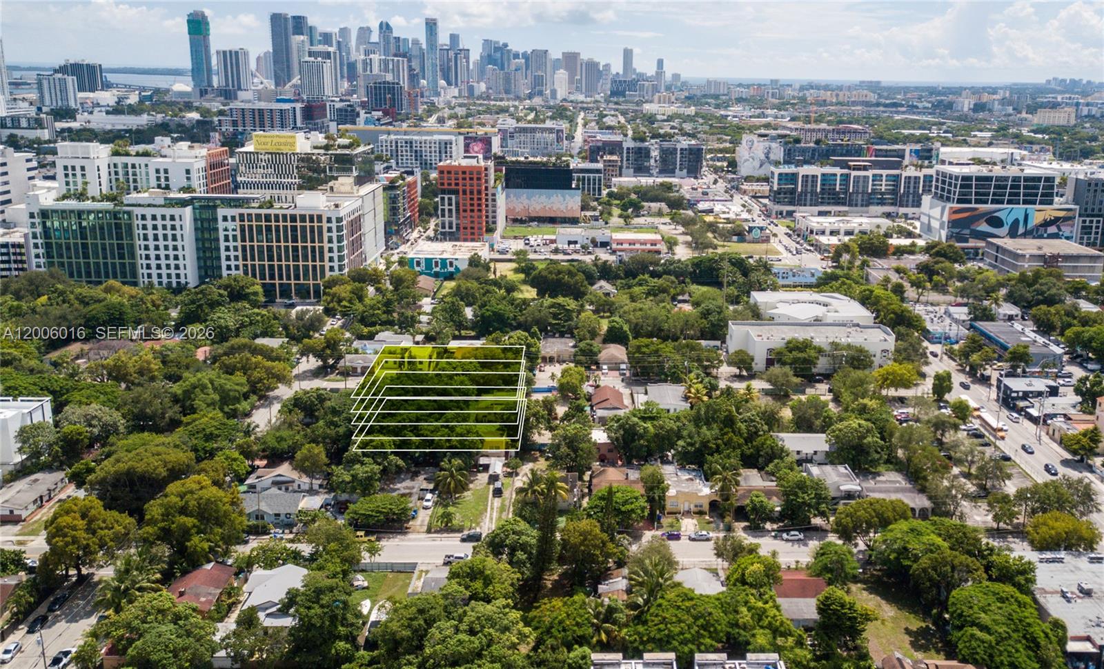 An aerial view shows a wooded lot highlighted with white outlines amidst a city neighborhood — 107 NW 31st St, Miami FL 33127, MIAMI, FL