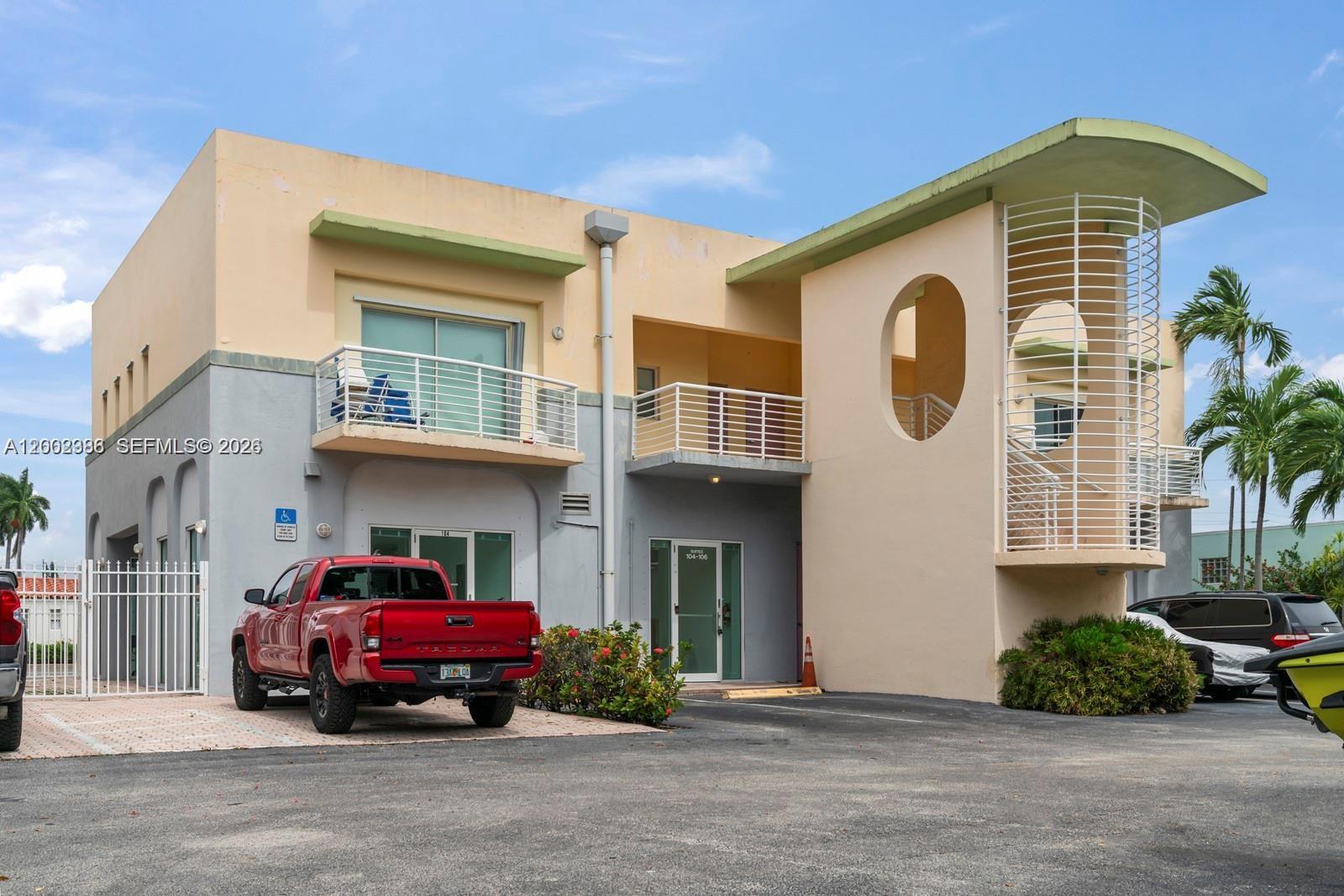 A two-story commercial building features a red pickup truck parked in front — 200 E Dania Beach Blvd, Dania Beach FL 33004, DANIA BEACH, FL