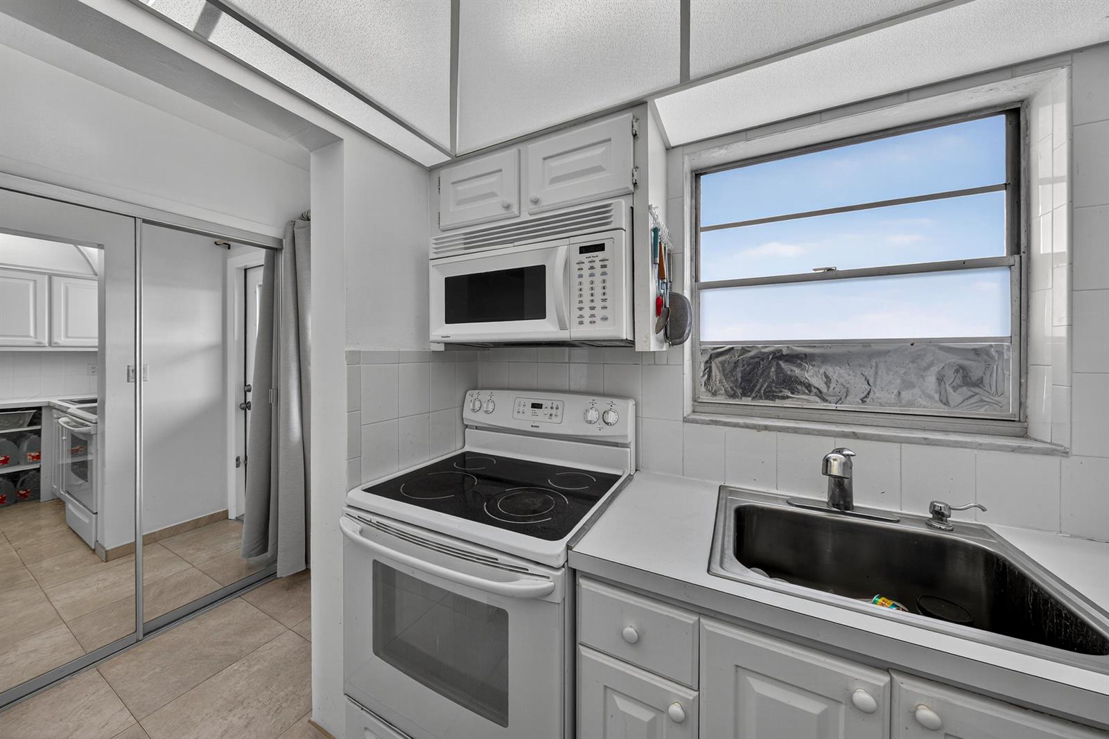 A kitchen features white cabinets, a refrigerator, a butcher block countertop, and a ceiling fan — 251 S GOLF Boulevard # 287, Pompano Beach FL 33064, POMPANO BEACH, FL