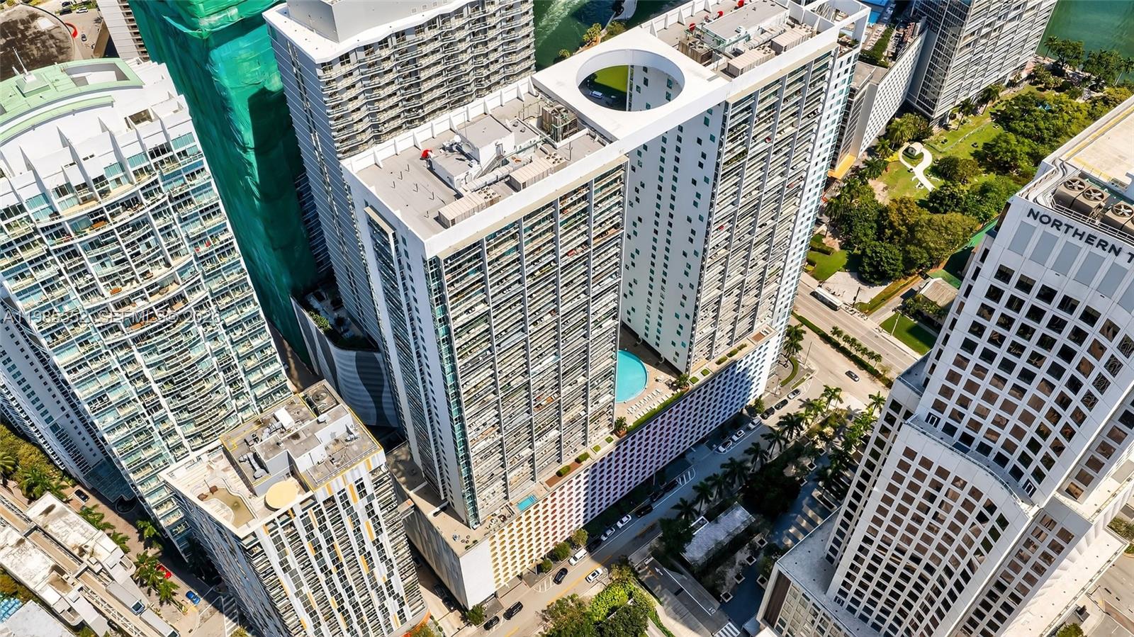 An aerial view shows several high-rise apartment buildings with a swimming pool on a terrace — 500 Brickell Ave # 3901, Miami FL 33131, MIAMI, FL