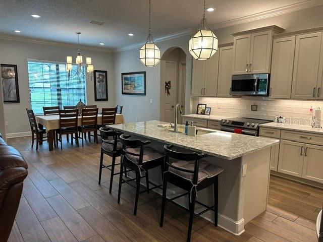A kitchen with a large island, light-colored cabinets, and an adjacent dining area — 5111 DISMUKE DRIVE, LAKELAND, FL