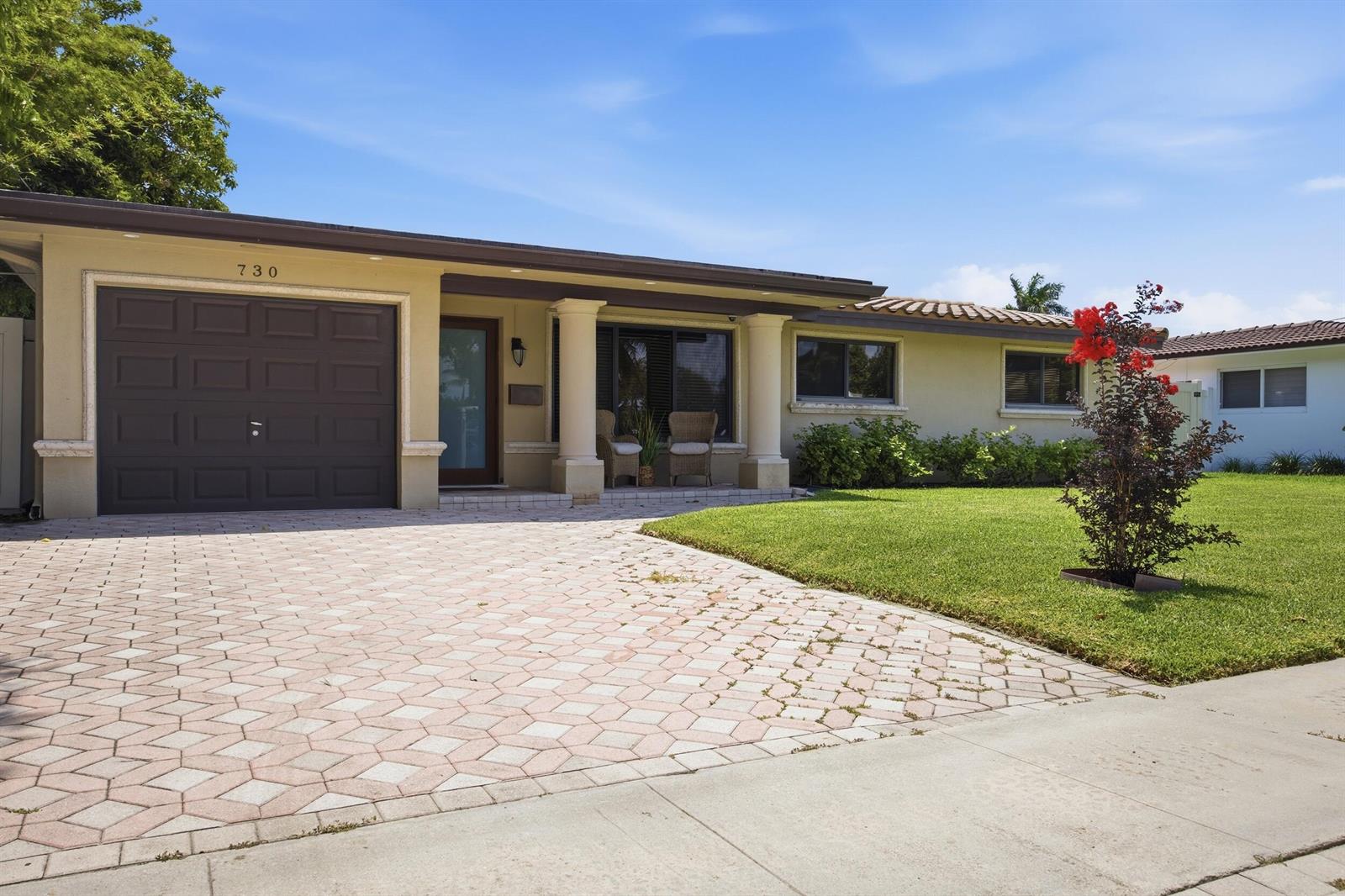 A single-story house with a paved driveway, two columns at the entrance, and a lawn — 730 SE 3rd Terrace, Pompano Beach FL 33060, POMPANO BEACH, FL