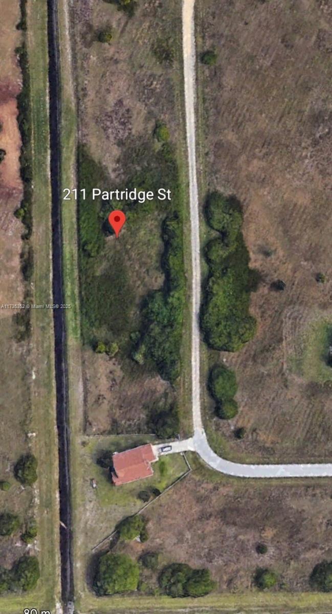 This is an aerial map view showing a vacant lot with a nearby house and road — 211 Partridge, Lehigh Acres FL 33974, LEHIGH ACRES, FL