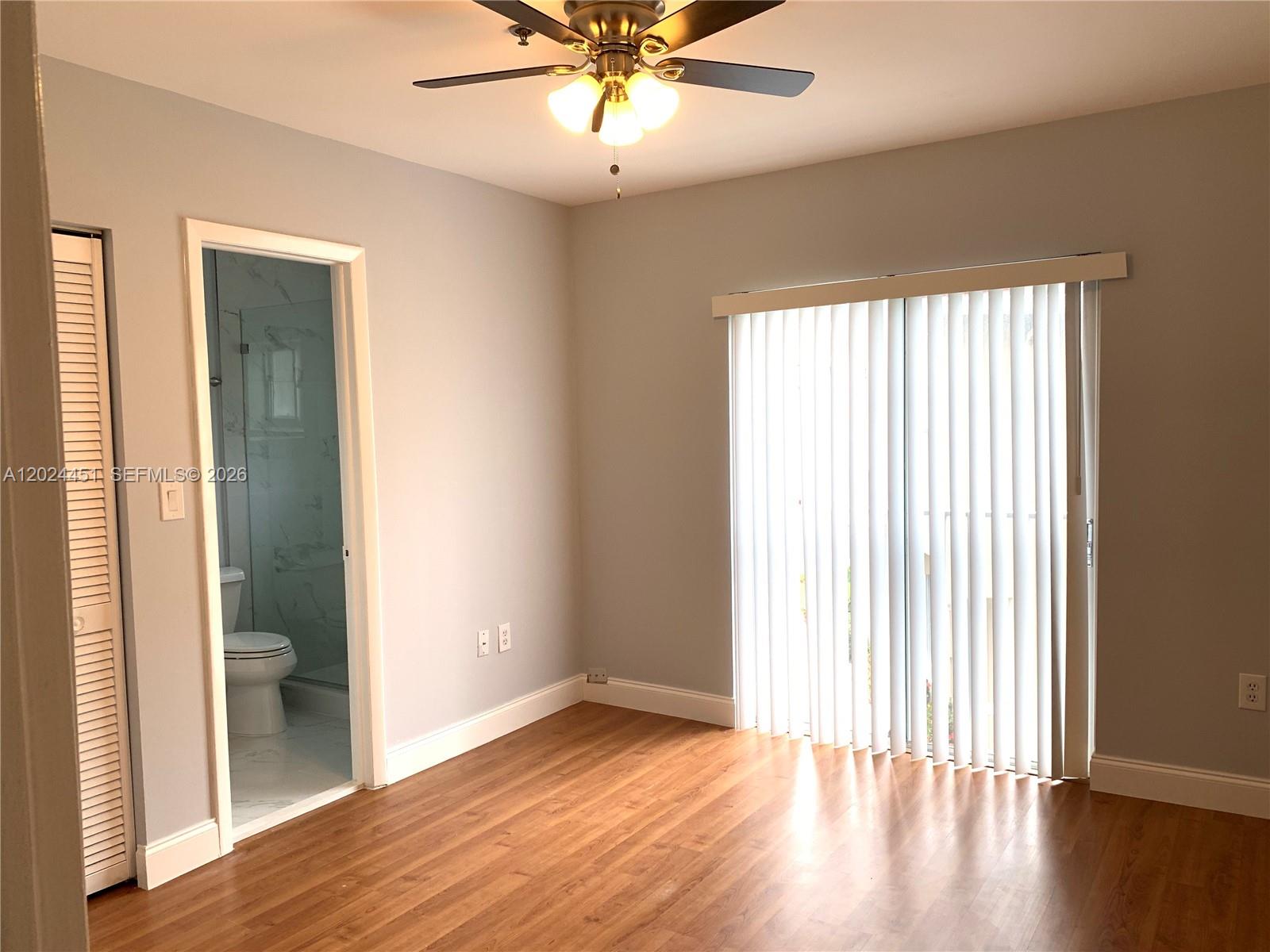 A kitchen features gray cabinets, stainless steel appliances, a white countertop, and tiled flooring — 143 Riviera Cir # 143, Weston FL 33326, WESTON, FL