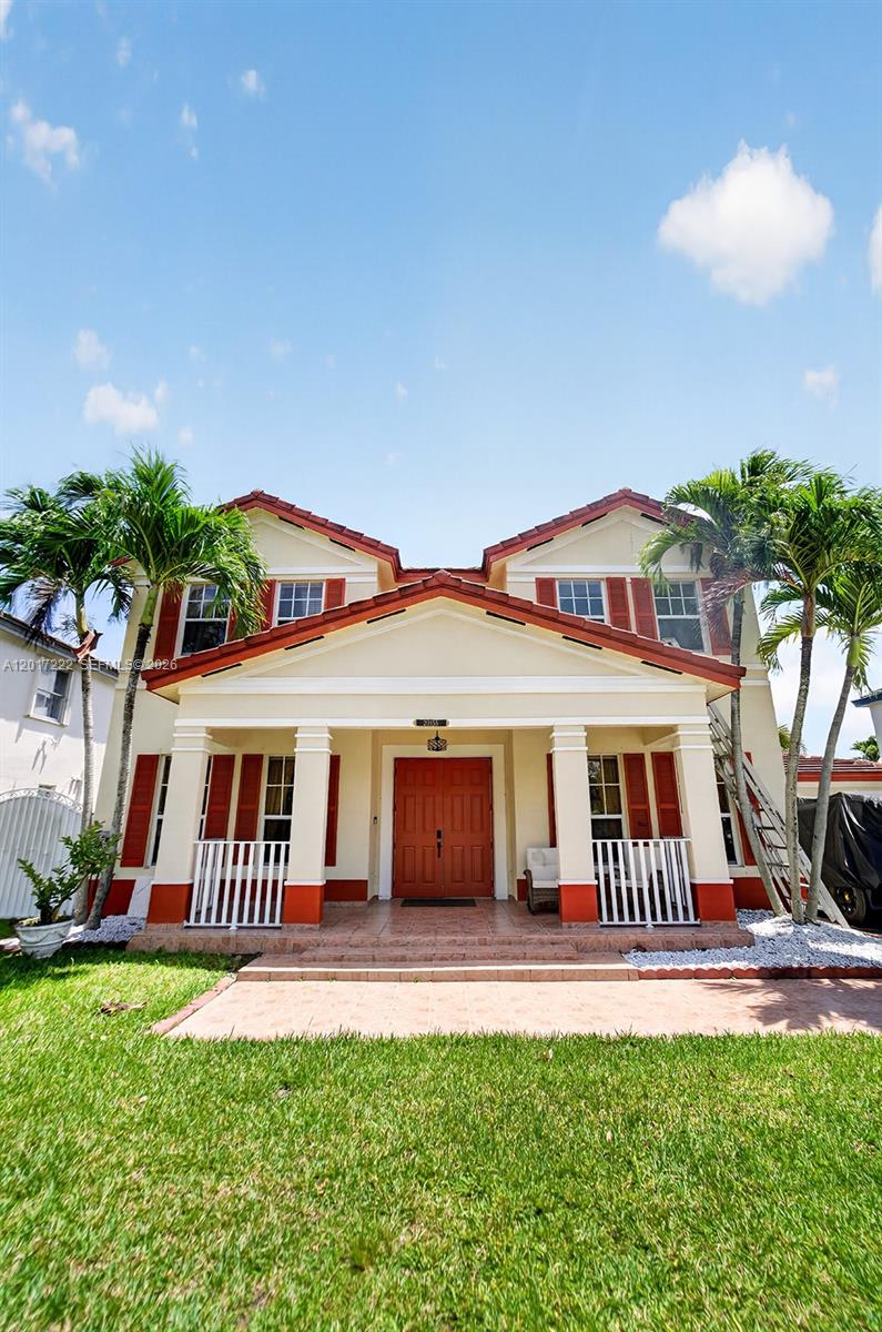 A two-story house with a covered front porch, red shutters, and palm trees — 20155 SW 129th Ave, Miami FL 33177, MIAMI, FL