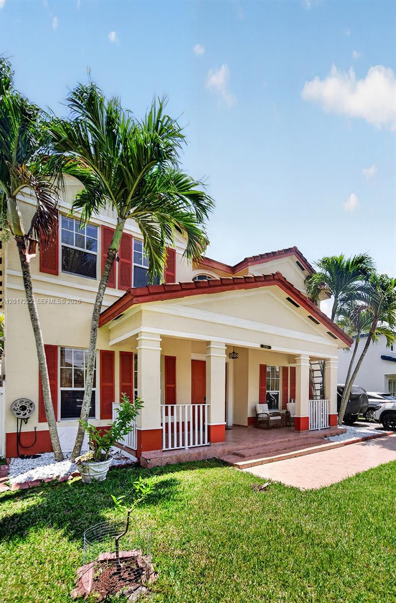 A two-story house with a covered front porch, red shutters, and palm trees — 20155 SW 129th Ave, Miami FL 33177, MIAMI, FL