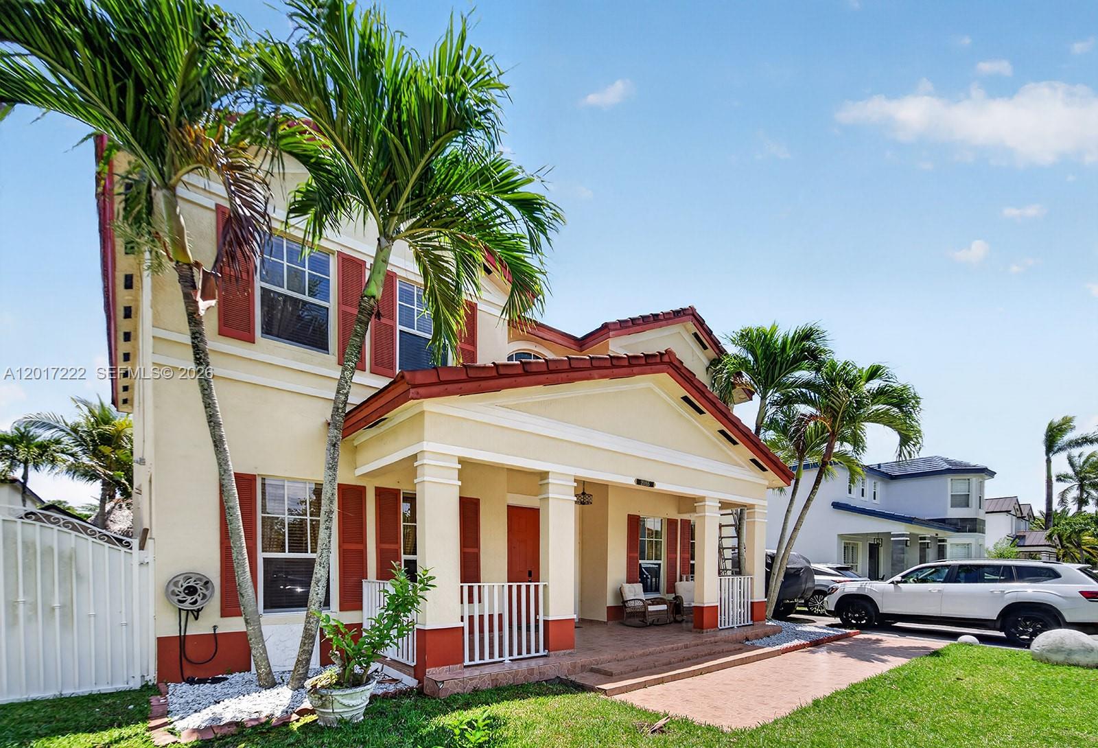 A two-story house with a covered front porch, red shutters, and palm trees — 20155 SW 129th Ave, Miami FL 33177, MIAMI, FL