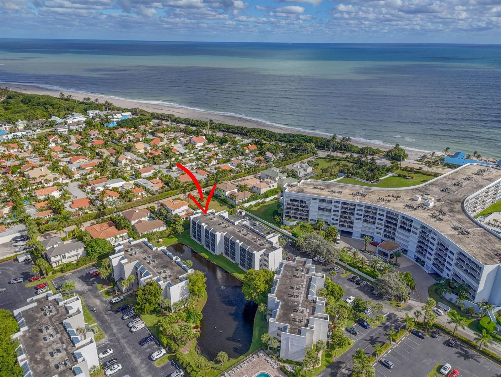 An aerial view shows a multi-story apartment building with a red arrow pointing toward it — 1605 S Us Highway 1 # A407, Jupiter FL 33477, JUPITER, FL