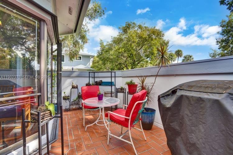A paved walkway leads to a gated entrance of a house with a screened patio — 10026 NW 52nd Ter, Doral FL 33178, DORAL, FL
