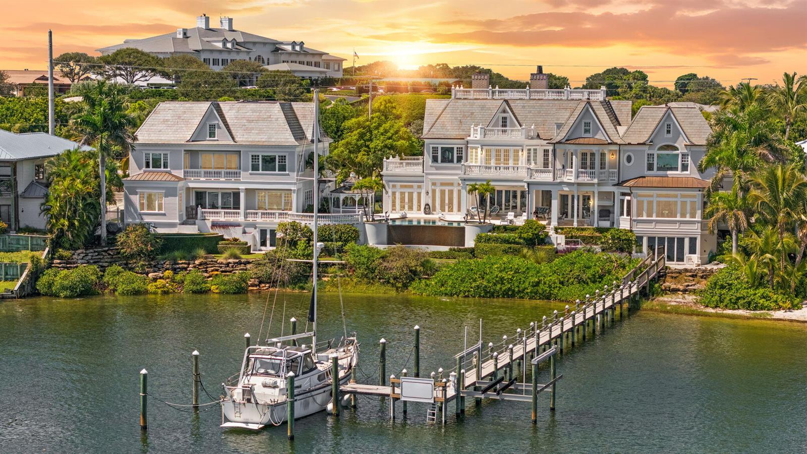 An aerial view of two large waterfront houses with a private dock and a boat — 17667 SE FEDERAL Highway, Jupiter FL 33469, JUPITER, FL