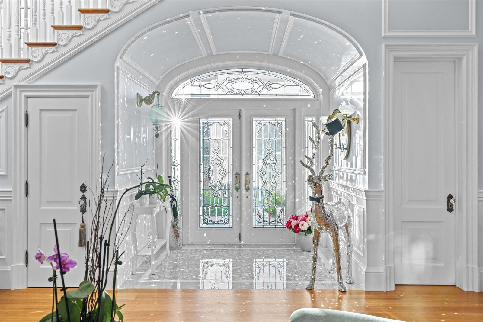 A bright foyer features a double glass door, a mirrored deer statue, and a staircase — 17667 SE FEDERAL Highway, Jupiter FL 33469, JUPITER, FL