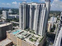 An aerial view shows a high-rise residential building with a rooftop pool and garden terrace — 999 SW 1st Ave # 3202, Miami FL 33130, MIAMI, FL