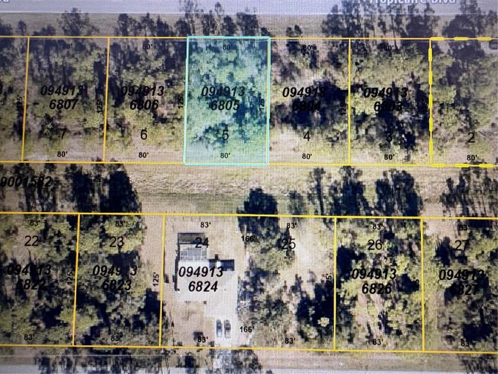 This is a satellite map showing property lot lines and parcel numbers for a residential area — TROPICAIRE BOULEVARD, NORTH PORT, FL