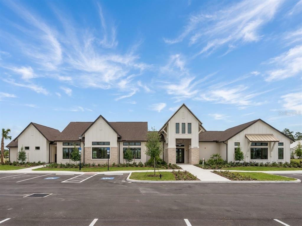 A single-story building with a gabled roof, stone accents, and a paved parking lot — 3511 HORNBEAM ROAD, SPRING HILL, FL