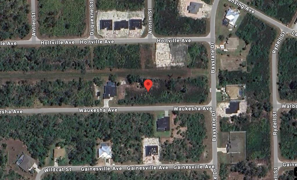 This is a satellite map view showing a vacant residential lot marked with a red pin — 13328 WAUKESHA AVENUE, PORT CHARLOTTE, FL