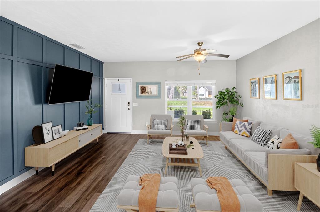 A living room features a blue accent wall, wood flooring, and neutral-toned furniture — 16659 NW 192ND TERRACE, HIGH SPRINGS, FL