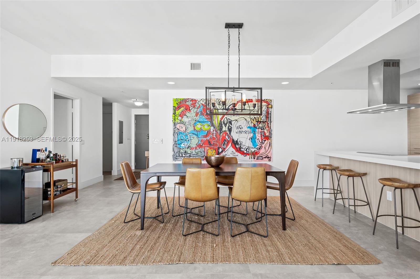 A modern dining area features a dark wood table, leather chairs, and vibrant abstract wall art — 17111 Biscayne Blvd # 2103, North Miami Beach FL 33160, NORTH MIAMI BEACH, FL