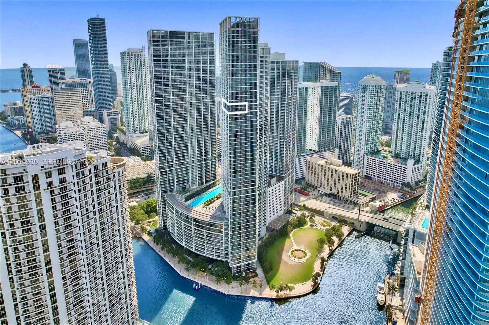 An aerial view of a modern high-rise building complex situated along a waterfront in Miami — 465 Brickell Ave # 4101, Miami FL 33131, MIAMI, FL