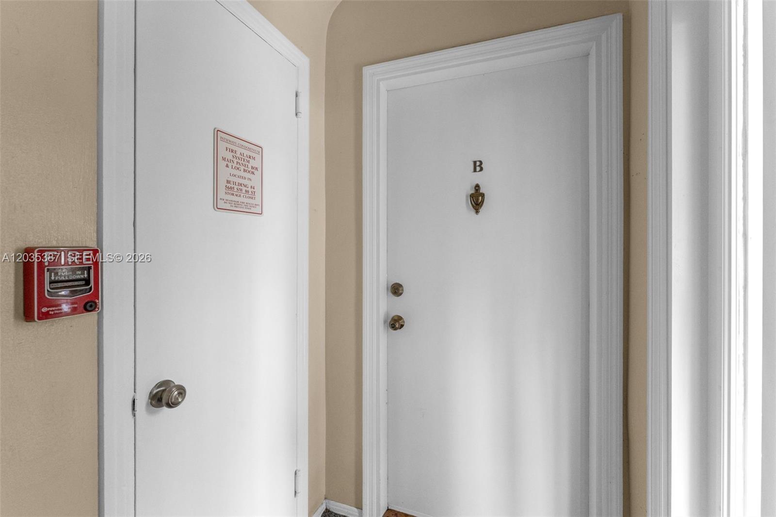 A hallway features two white doors, one marked with a B and a fire alarm — 5685 SW 80th St # 58B, Miami FL 33143, MIAMI, FL