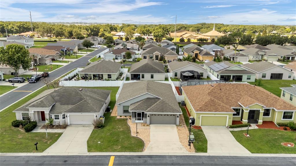 An aerial view shows a row of suburban houses with driveways and lawns — 1144 HIGH SEAS STREET, WINTER HAVEN, FL