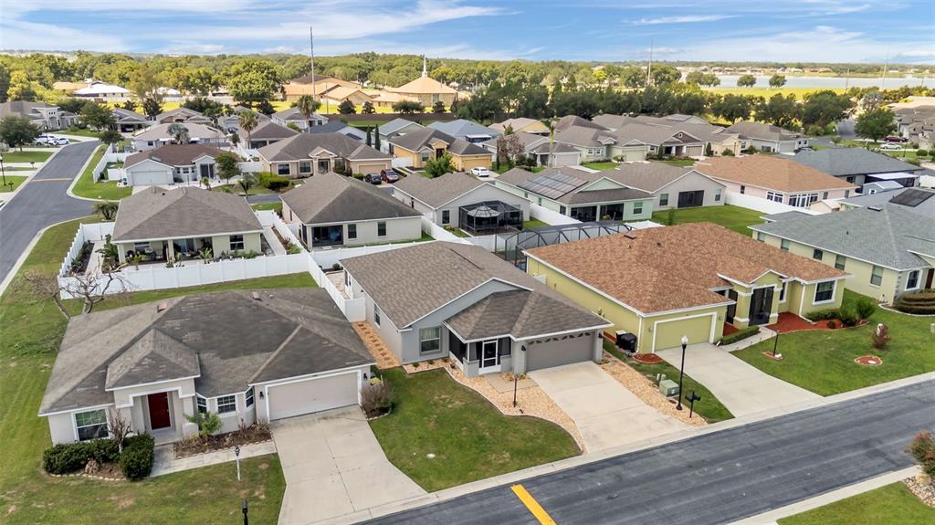 An aerial view shows several suburban single-family homes with driveways and lawns — 1144 HIGH SEAS STREET, WINTER HAVEN, FL