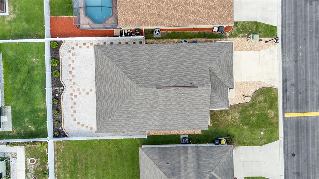 An aerial view shows a residential house with a shingled roof and a backyard patio — 1144 HIGH SEAS STREET, WINTER HAVEN, FL