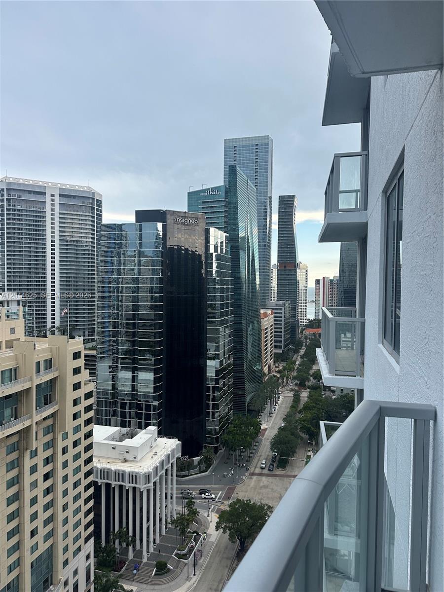 A high-angle view from a balcony overlooking a city street and surrounding skyscrapers — 1060 Brickell Ave # 2505, Miami FL 33131, MIAMI, FL
