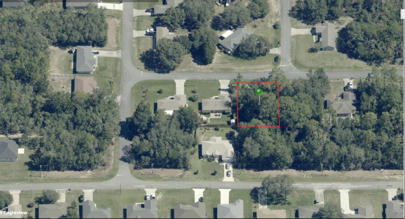 An aerial view shows a vacant, wooded residential lot outlined in red — 544 W La Casita Lane, FL 34434, FL