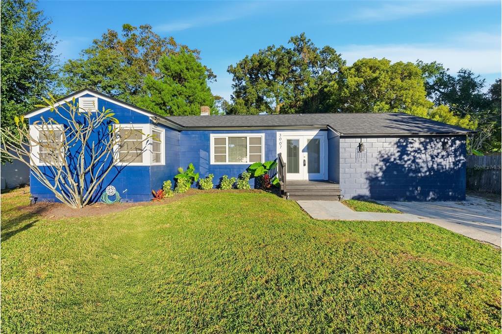 A single-story blue house with a dark roof, white-trimmed windows, and a front entrance — 3007 KNOLLWOOD CIRCLE, ORLANDO, FL
