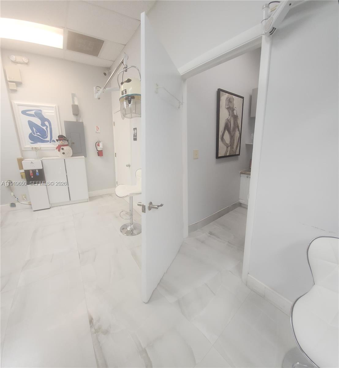 A bright room with white tiled floors, a hair dryer, and an open doorway — 14707 SW 42nd St # 401, Miami FL 33185, MIAMI, FL