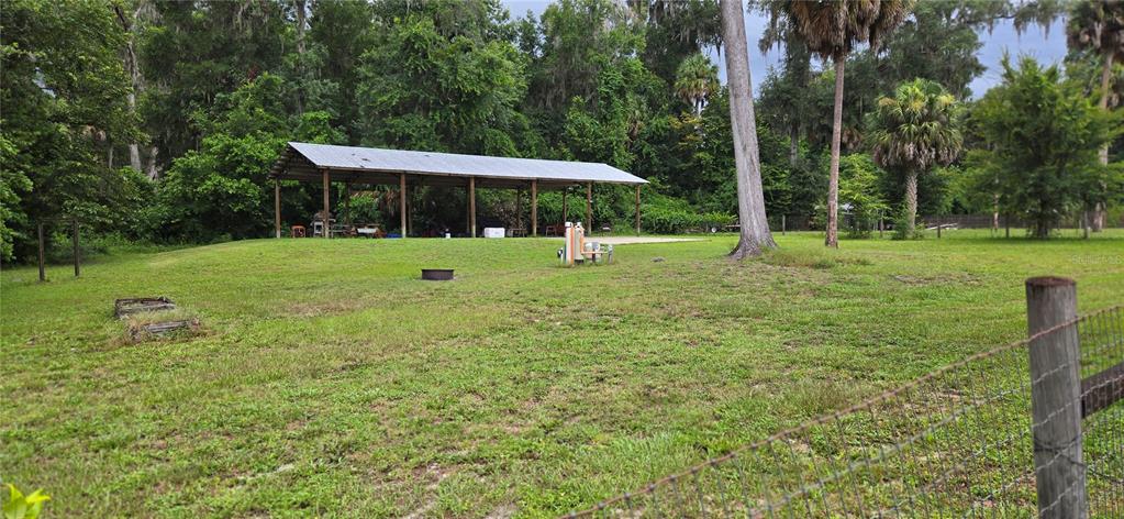 A single-story house with a gray shingled roof, two dormers, and a covered front porch — 13930 NE 41ST TERRACE, ANTHONY, FL