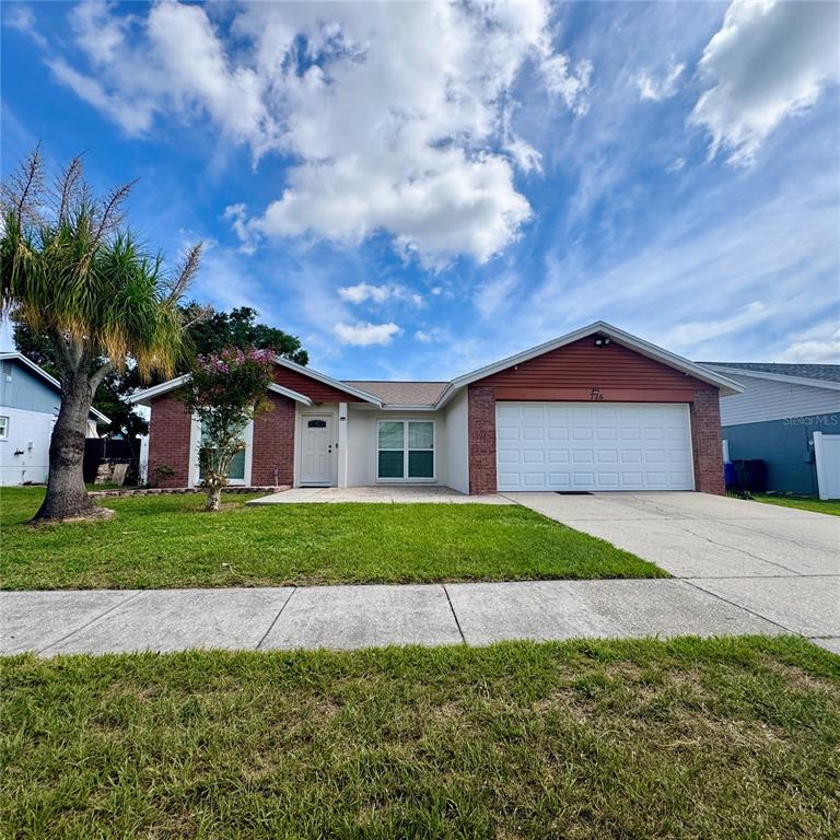 A single-story house with a white garage door, brick accents, and a front lawn — 726 STILLVIEW CIRCLE, BRANDON, FL