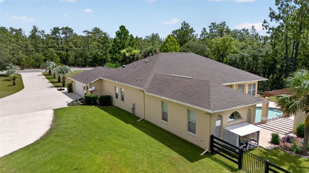 An aerial view of a tan house with a pool, patio, and large grassy yard — 4348 W BONANZA DRIVE, BEVERLY HILLS, FL