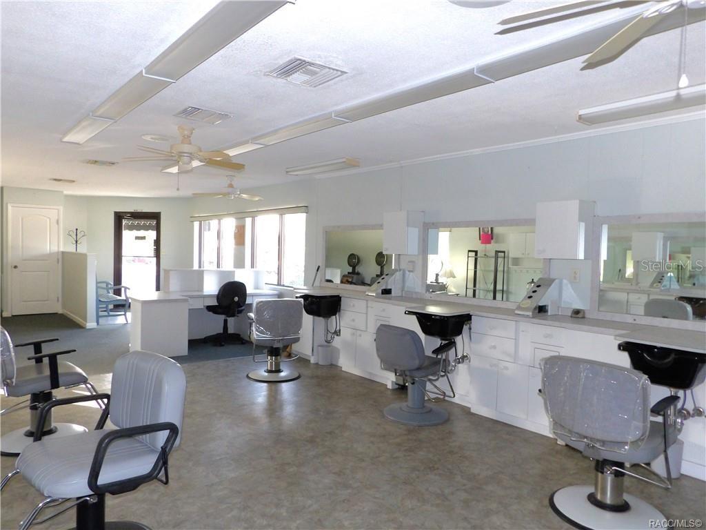 A hair salon features multiple styling stations with chairs, mirrors, and sinks on a linoleum floor — 3822 E PARSONS POINT ROAD, HERNANDO, FL