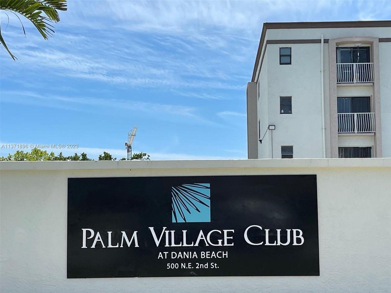 The exterior sign for Palm Village Club is mounted on a wall below a building — 500 NE 2nd Street # 204, Dania Beach FL 33004, DANIA BEACH, FL