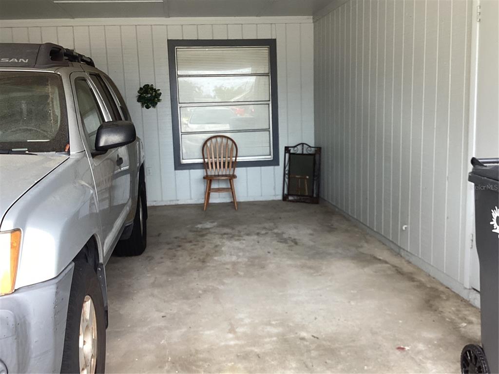 A single-story house features a concrete driveway, a carport, and a palm tree — 4007 78TH STREET W, BRADENTON, FL