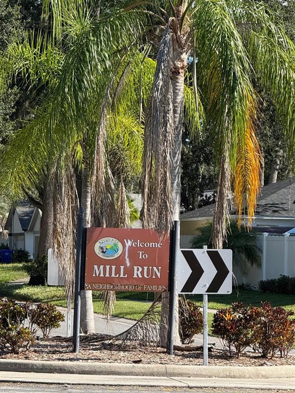 A sign reading Welcome To Mill Run stands in front of a palm tree — 2808 MILL RUN BOULEVARD, KISSIMMEE, FL
