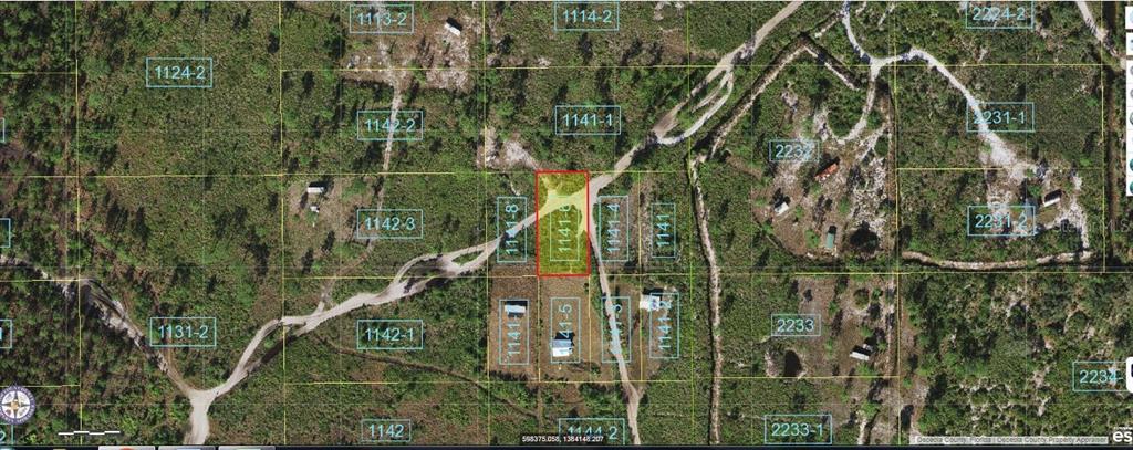 This is an aerial map showing a highlighted rectangular land parcel with surrounding dirt roads — HOLOPAW GROVES ROAD, ST CLOUD, FL