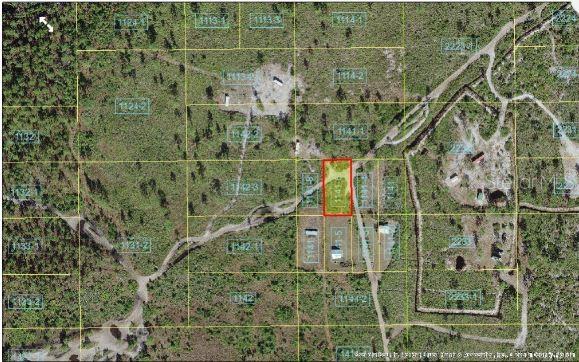 This aerial map shows a rectangular plot of land highlighted in red among surrounding lots — HOLOPAW GROVES ROAD, ST CLOUD, FL