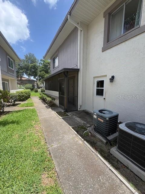 A screened-in patio area is visible next to a white exterior wall and a sidewalk — 1839 BOUGH AVENUE UNIT B, CLEARWATER, FL